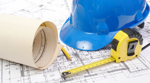 Commercial building plans with hard hat
